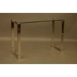 A glass and chrome console table, with square tubular supports to either end, 110 x 40 x 76cm