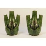 A pair of Continental crocus vases, the green bulbous body fitted triple elongated cylindrical