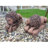 A pair of terracotta lions, after originals by Canova, 45cm long