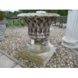 A Haddonstone basket weave garden urn, with four lion's paw feet, on stepped square plinth, urn 83cm
