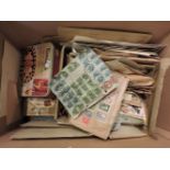 A box of World and Commonwealth postage stamps, in tins, boxes and packets, mainly older stamps