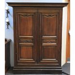 A 19th century Flemish carved oak armoire with moulded cornice, above a pair of panel doors on a