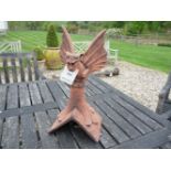 A winged gargoyle roof ridge tile, 28cm wide x 28cm deep x 51cm high