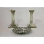 A pair of silver Corinthian column candlesticks, loaded bases, 11.5cm high, and a pierced dish,