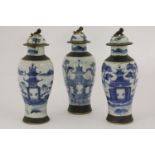 A garnaiture of three Chinese blue and white vases, 20th century, all coves restored, 27cm high