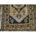 An antique Middle Eastern blue ground rug, 180 x 108cm, together with a further similar (2)