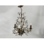 A hanging pressed metal three light electrolier, of foliate form with hanging glass drops, 60cm