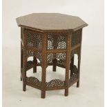 A hardwood brass copper inlaid octagonal table, with mashrabiya panels, 60.5cm diameter