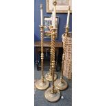A set of four wood and gilt standard lamps