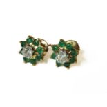 A pair of gold illusion set diamond and emerald cluster earrings, (tested as approximately 18ct gold