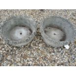 A pair of cast stone circular Haddonstone? planters, with flower decorated rims, 63cm diameter x