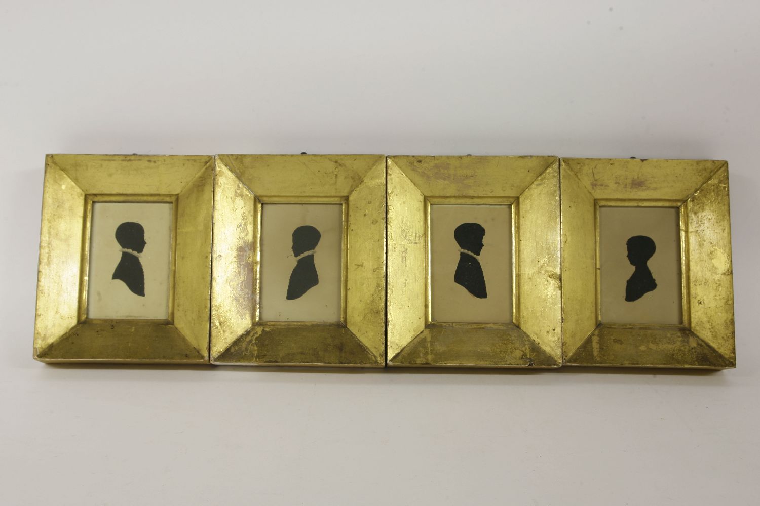 A set of four Victorian painted silhouettes, of children of the Pullman family