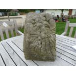 A hand carved salvaged corner stone of a green man, 29cm wide x 28cm deep x 31cm high