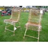 A pair of wrought iron garden chairs