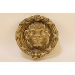 A large brass door knocker, with lions mask with cast ring handle, 23cm diameter
