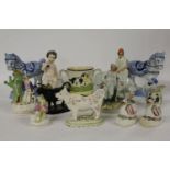 A collection of mixed Staffordshire items, a pair of swan baskets, a cricketer, a loving cup, a