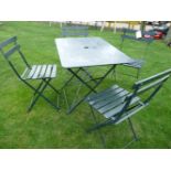 A folding garden table, and four chairs