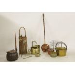 A collection of brass jam pans, a wicker basket, fire irons, a copper lidded saucepan, kettle,