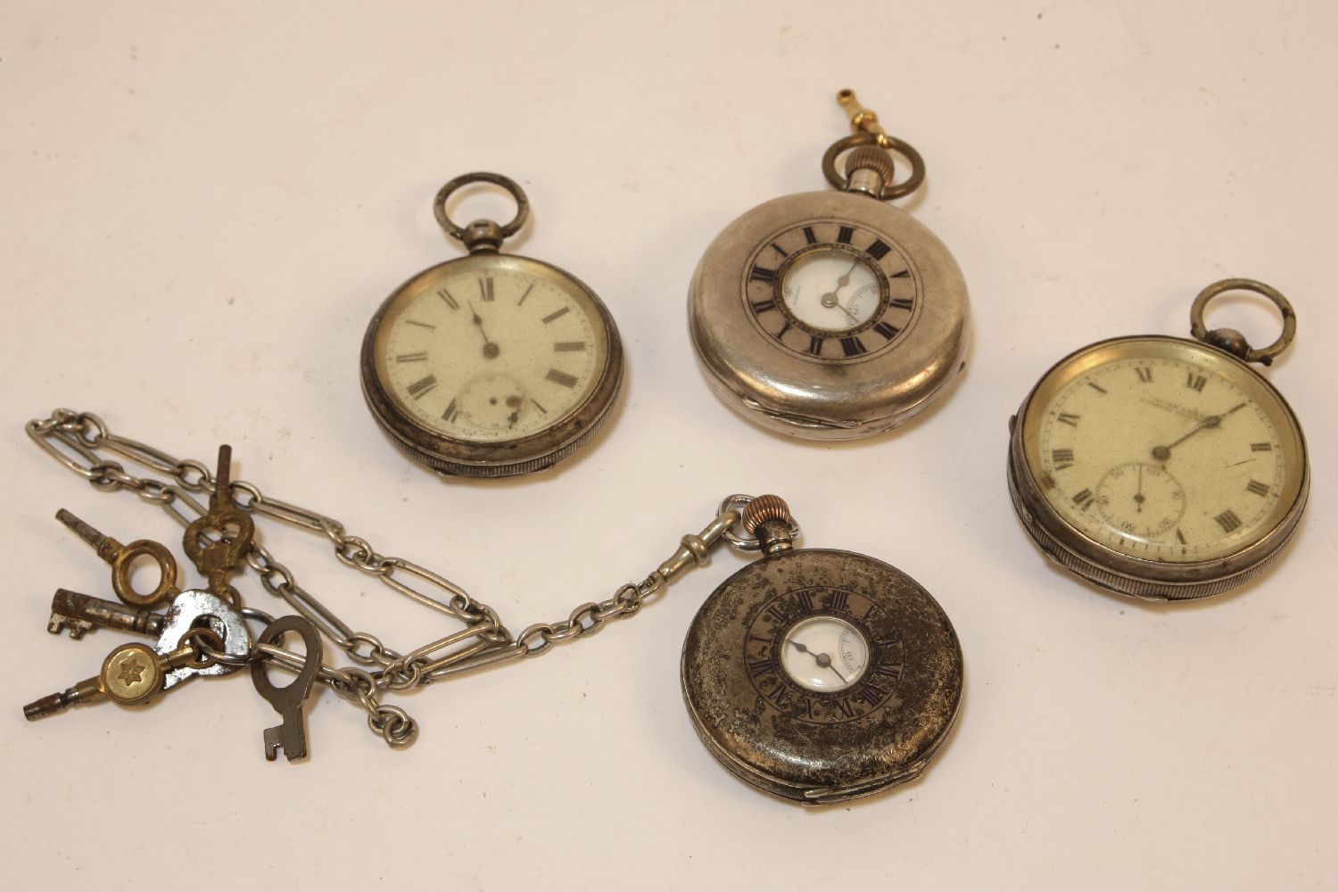 A Rotherams silver half hunter pocket watch, and three other pocket watches