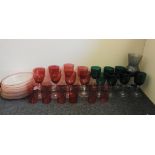 A set of six Cranberry glass beakers, similar wine goblets, and a collection of similar green wine