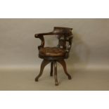 A Victorian revolving desk chair, with initials to the back, leather seat