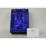 A pair of Harrods cut glass champagne flutes, boxed, 30cm high