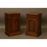 A pair of mahogany bedside cabinets, having frieze drawer above arch panel door, on plinth base,