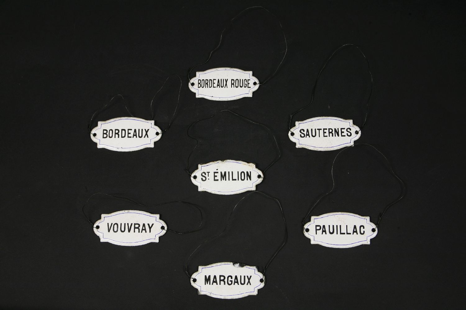 Seven enamelled wine labels, 8cm wide - Image 2 of 2