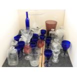A collection of mixed glassware, including a continental glass gin bottle, a large clear glass bowl,