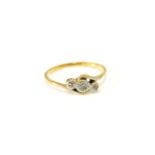 A gold three stone diamond ring, marked 18ct and plat, 2.10g