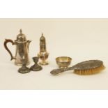 A silver water pot together with a silver sugar basin, a repousse decorated hairbrush, a pair of