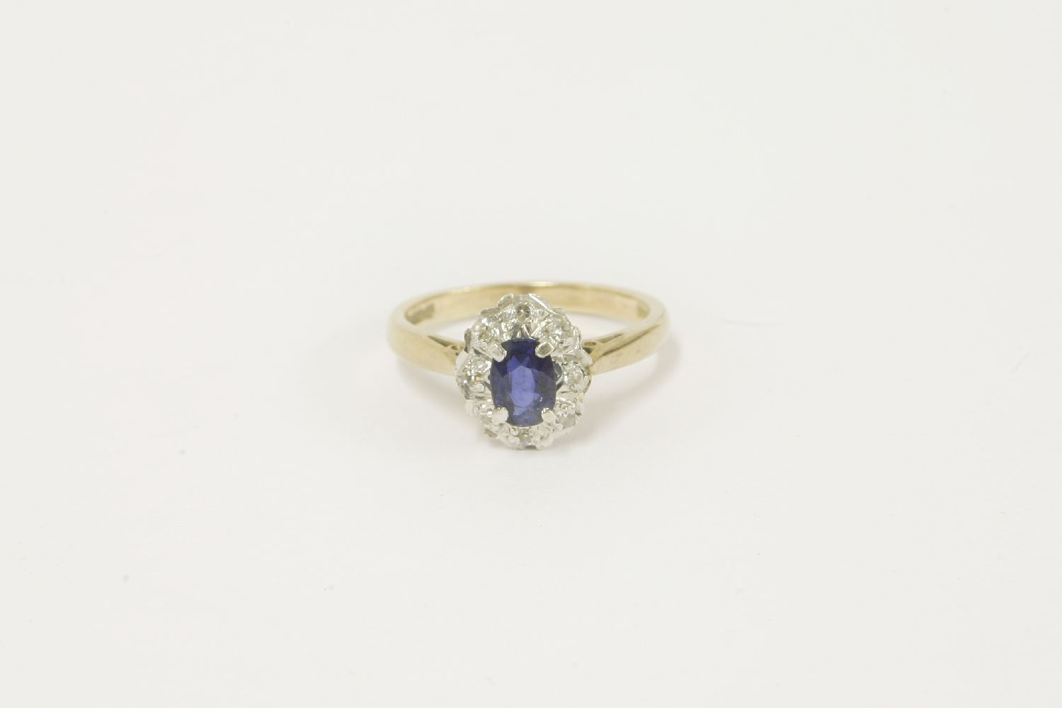 A 9ct gold sapphire and diamond oval cluster ring, size J leading edge J½2.55g