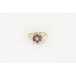 A gold diamond and ruby cluster ring, marked 18ct, size J 3.25g