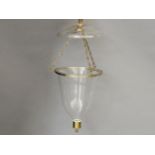 A clear glass hanging lampshade and cover, with brass mounts, 38cm high