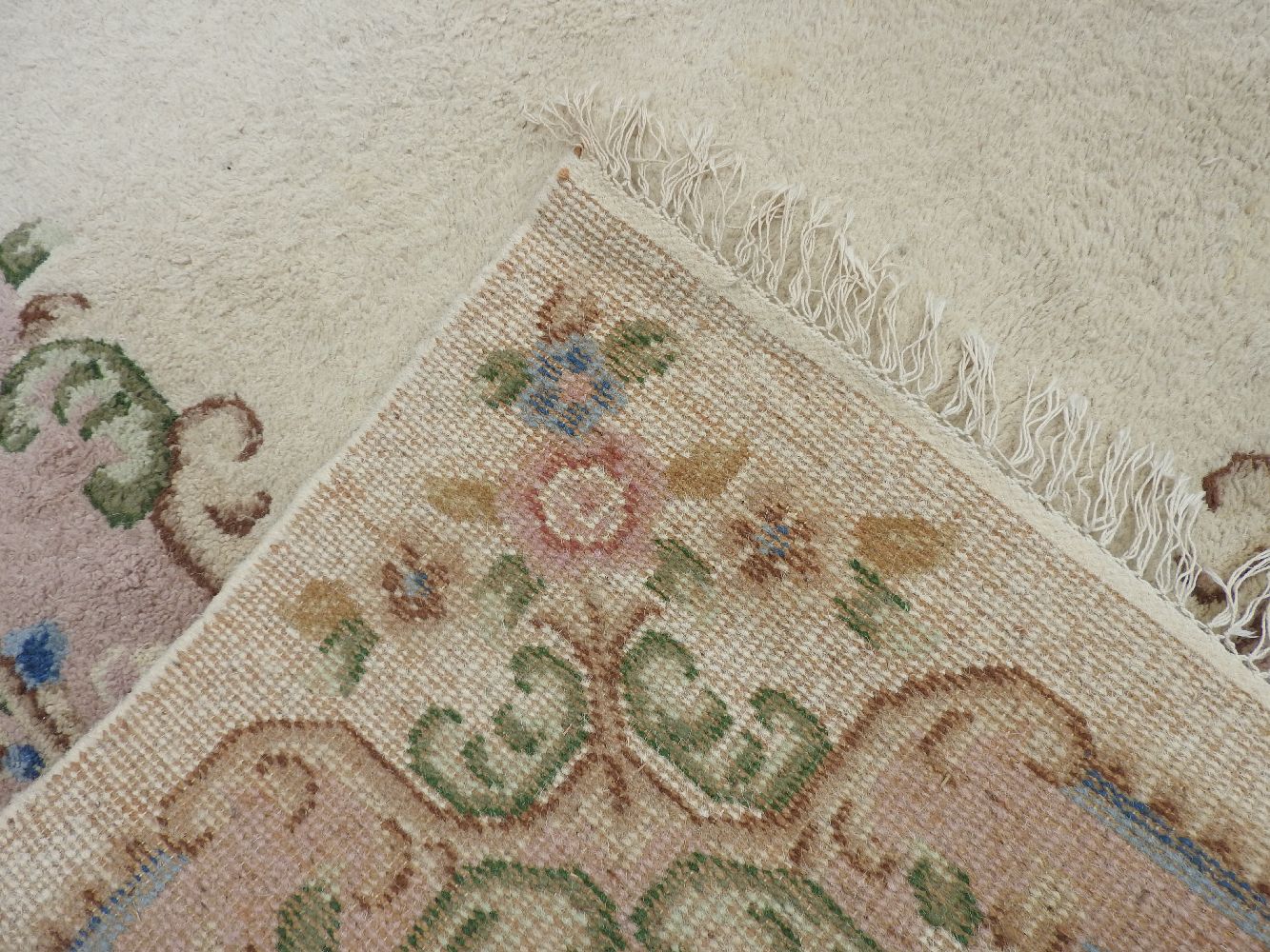 A large, possibly French, carpet, cream ground decorated with floral motifs - Image 2 of 2