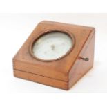 An Edwardian oak cased desk top barometer, by Negretti & Zambra, London, No. 5466, barometer 12cm