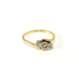A gold three stone diamond crossover ring, marked 18ct and plat,2.47g