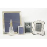 Four modern silver photography fames, and a cut glass scent bottle with silver mount