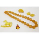 A single row graduated amber bead necklace, with gilt metal screw clasp, a pair of Russian