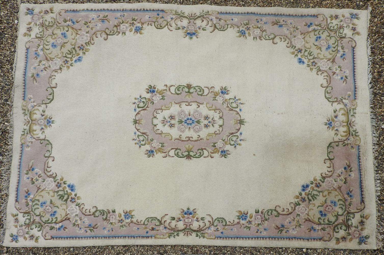 A large, possibly French, carpet, cream ground decorated with floral motifs