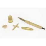 A gold thimble (tested as approximately 15ct), a rolled gold self propelling pen, a gold signet