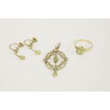 A gold single stone rub set oval cut peridot ring, marked 18ct by Deakin and Francis, An Edwardian
