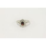 A 9ct white gold garnet and diamond oval cluster ring, size M½2.32g