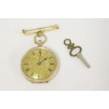 A 9ct gold Swiss fob watch, with engraved dial and Roman numerals with gilt metal bar brooch27.20g