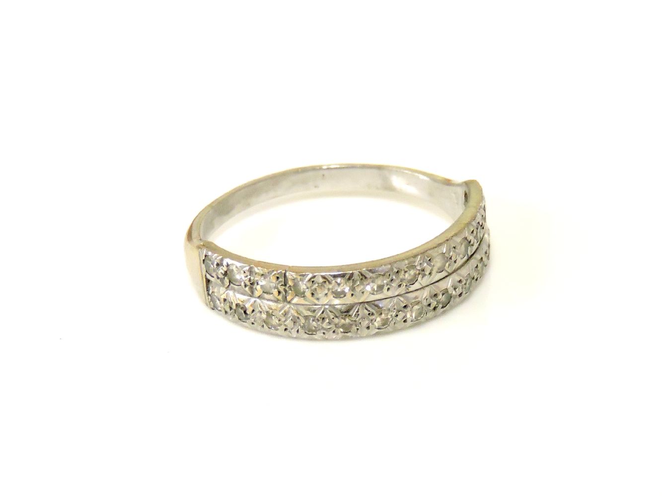 A white gold two row diamond half eternity ring, tested as approximately 18ct gold.6.97g