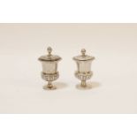 A pair of 19th century Chinese export silver peppers, of Campagna urn form, with half gadrooned