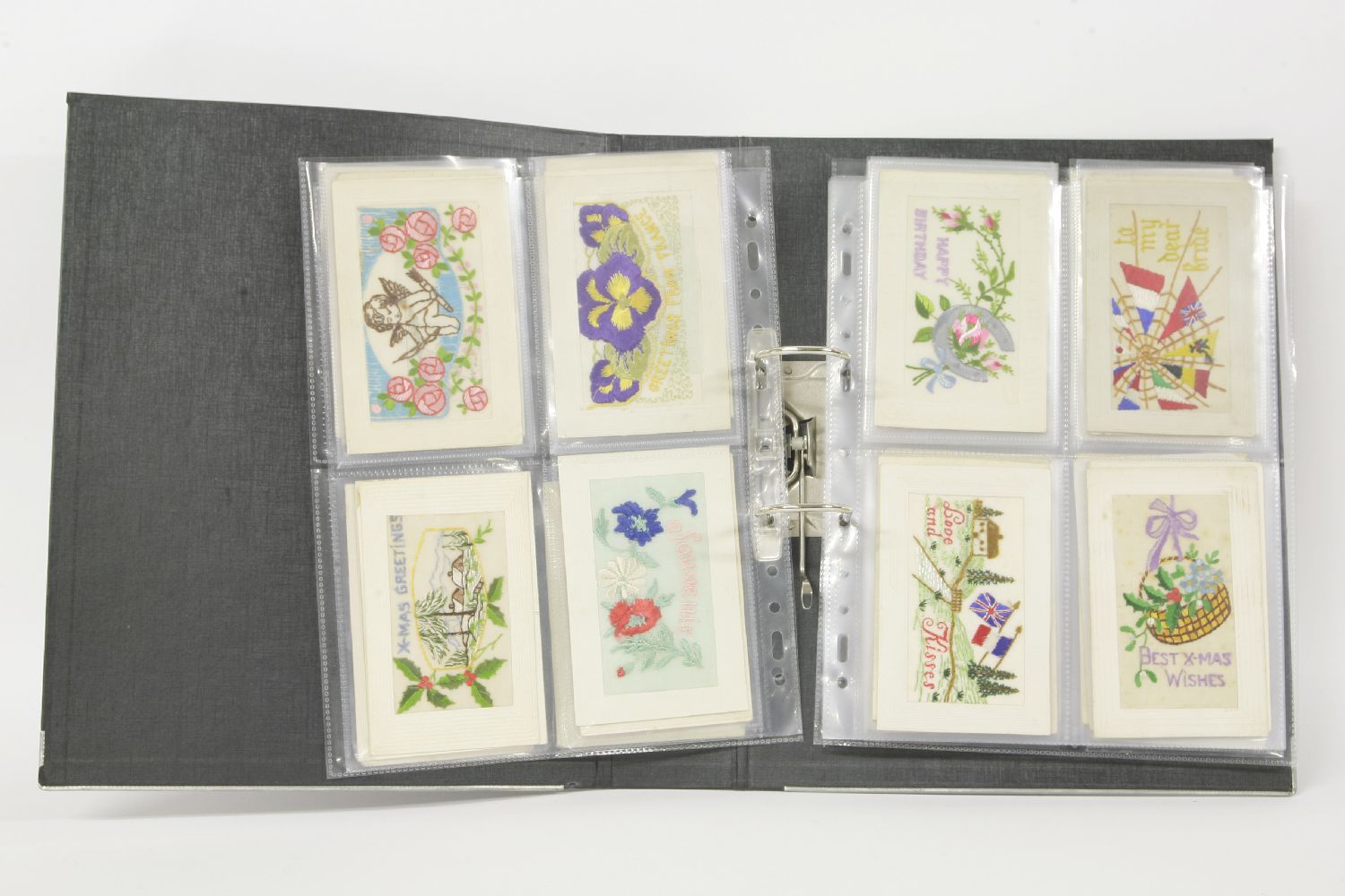 A postcard album, with embroidered cards, study cards, etc.