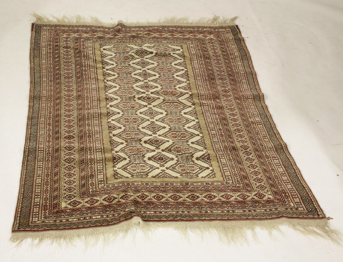 A Persian rug, cream ground with red geometric design