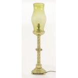 A Gothic Revival brass table lamp, with cabochons and a green glass shade, converted to electricity,