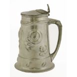An Art Nouveau pewter-lidded tankard, by Oliver Baker for Liberty & Co., having raised floral